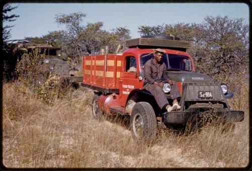 Kernel Ledimo sitting on the expedition red Dodge truck