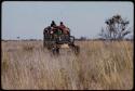 Expedition truck driving through grass