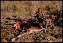 Oukwane and Gai butchering a gemsbok, Oukwane drinking from a hollow in the ground