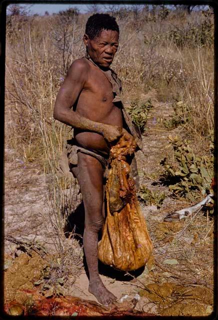 Oukwane holding a filled gemsbok stomach