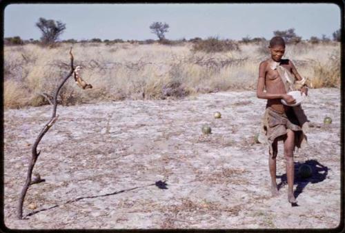 /Twikwe holding a bowl and walking through a field with tsama melons