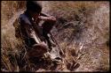 /Twikwe digging at a root with a digging stick