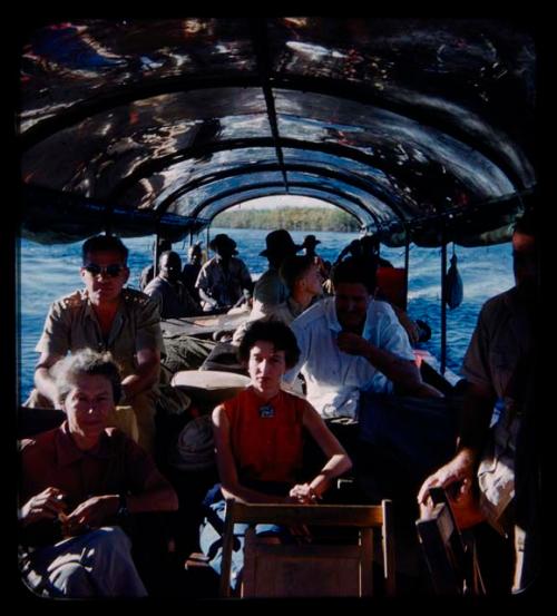 Group of people riding in a barge on the Kavango River; including expedition members, Anneliese Scherz, Lorna Marshall, and C.J. Mathias