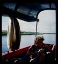 Elizabeth Marshall Thomas sitting in a barge on the Okavango River