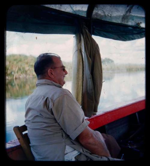 C.J. Mathias sitting in a barge on the Okavango River