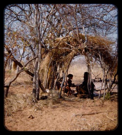 Children, Mothers: Mother sitting with her child in a skerm