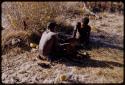 Gai, Tsekue, and N!whakwe sitting together