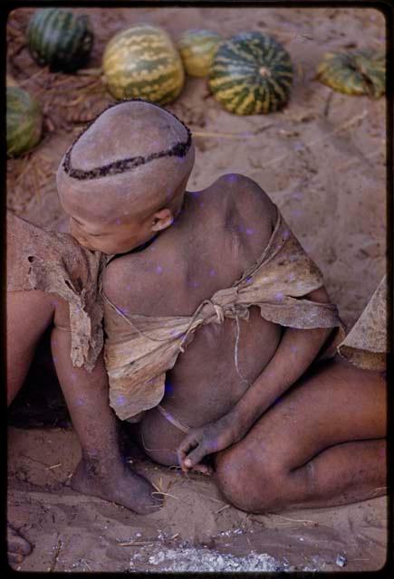 Boy sitting, seen from behind