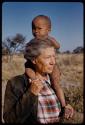 Lorna Marshall standing with N!whakwe on her shoulders, close-up