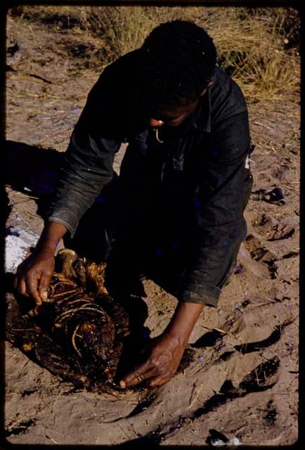 Philip Hameva holding cooked springbok joint, close-up