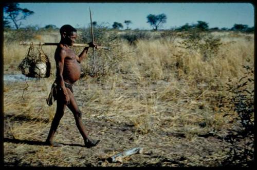 Carrying: Gao (father of Sa//gai) visiting Gautscha, carrying at least one ostrich eggshell in a carrying net hanging on a stick over his shoulder