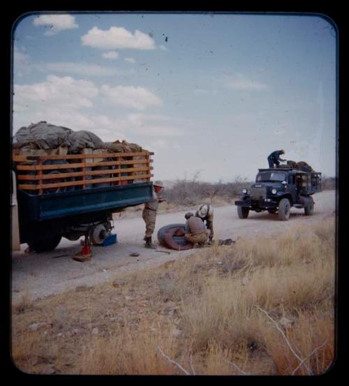 J. Otis Brew replacing a tire on an expedition truck