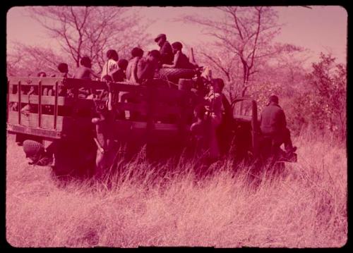 People sitting in the back of an expedition truck, getting ready to leave for the mangetti forest