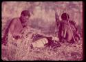 "Gao Medicine" and another man lighting a fire for the night, with their bows and quivers on the ground next to them