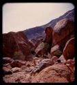 People walking between boulders on Brandberg Mountain