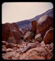 People standing next to boulders on Brandberg Mountain