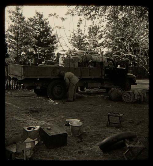 Person checking a tire on an expedition truck