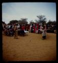 Omajetti indaba, group of women standing around men sitting next to a table