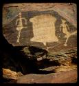 Petroglyphs of humans standing next to an animal skin, close-up