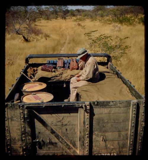 Laurence Marshall sitting in the back of an expedition truck