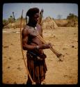 Man standing, carrying bow and arrows