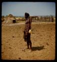 Man standing, carrying bow and arrows, profile