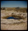 Waterhole, with a trough for goats and cattle in the background