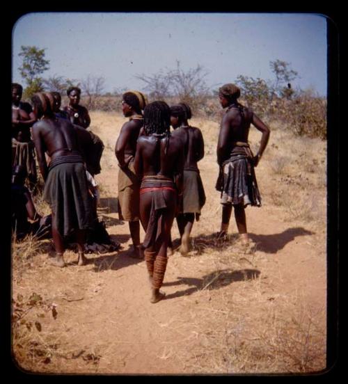 Group of people standing, view from behind