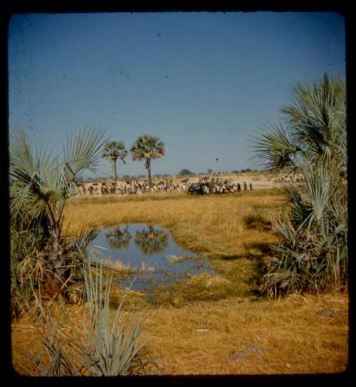 Large group of people standing around a SWNLA truck stuck in mud