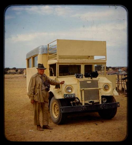 Merl La Voy standing next to an expedition truck