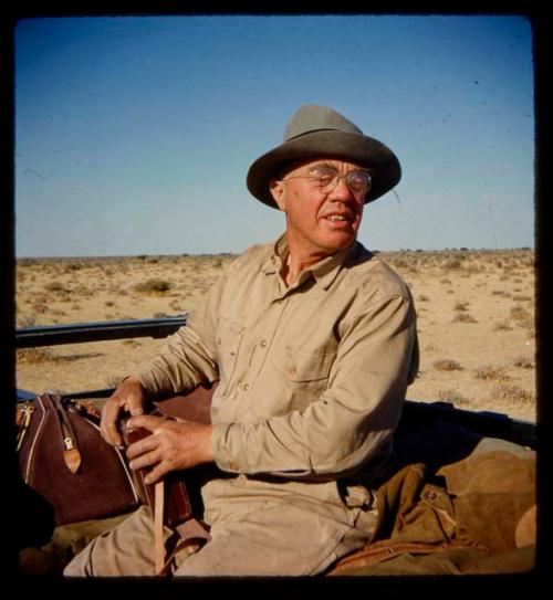 Laurence Marshall riding in an expedition truck