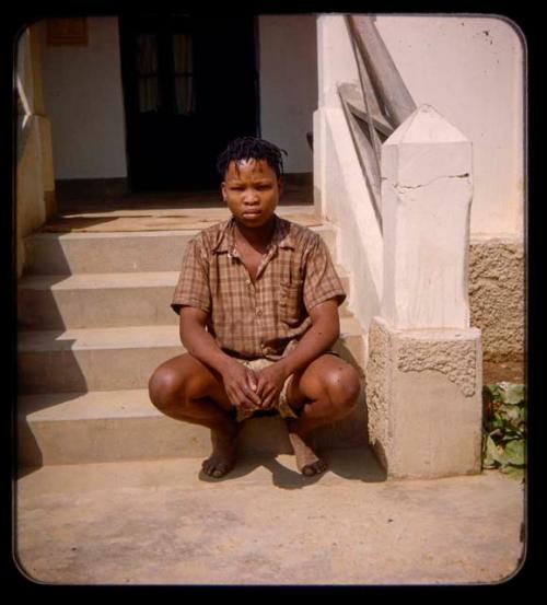 Boy sitting on the steps of a building