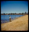 Heinrich Neumann standing on the bank of the Okavango River