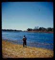 Heinrich Neumann standing on the bank of the Okavango River