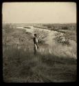 Man standing, looking at the Okavango River