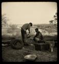 John Marshall and another man in the expedition camp, with the Okavango River in the background