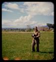 Franz Malan standing on his property, holding a camera