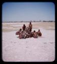 Group of men cutting up wildebeests in a pan