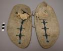 Pair of Plains moccasins, possibly Sioux. Soles made from parfleche, designs o