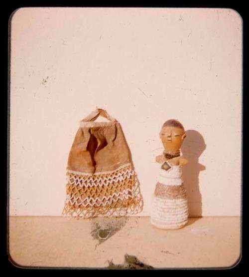 Decorated textile and a figurine of a woman