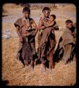 Three women standing, one holding a baby