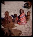 Two women sitting with two children, view from behind