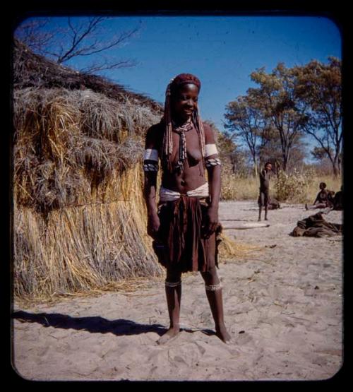 Married woman standing, with a child standing in the background