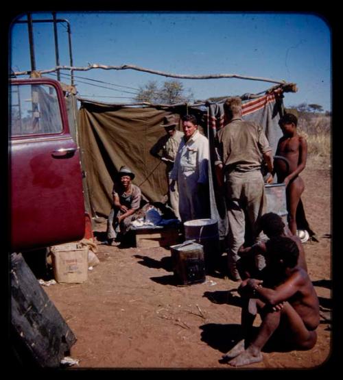 People waiting with Eric Williams and other expedition members for a person's face cast to dry