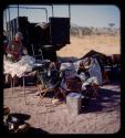 Lorna Marshall preparing gifts in front of an expedition truck