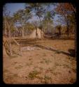 Person sitting near Coutimwe's hut in Meri Catinga's kraal