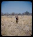 Carrying: Woman carrying a bag on a stick