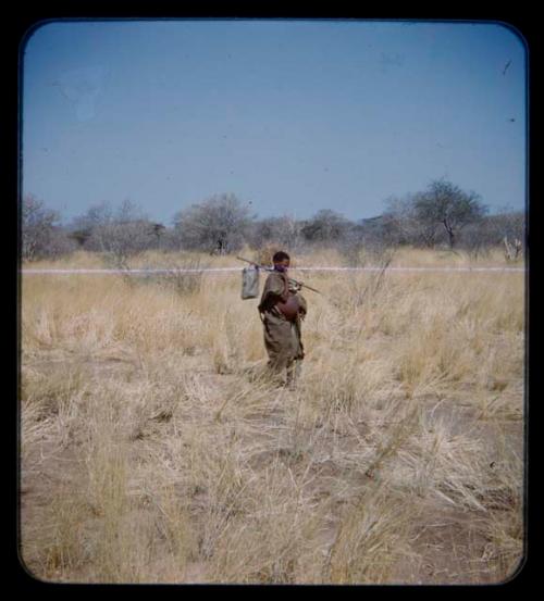 Carrying: Woman carrying a bag on a stick