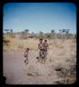 Children, Mothers nursing babies: Visiting woman standing and holding child, with another child standing nearby