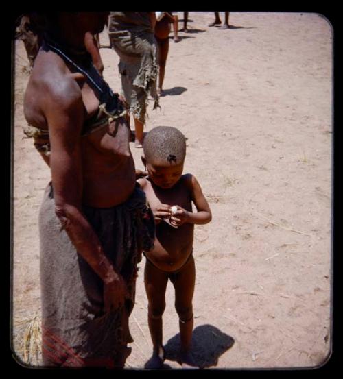 Children, Mothers nursing babies: Child and a woman standing